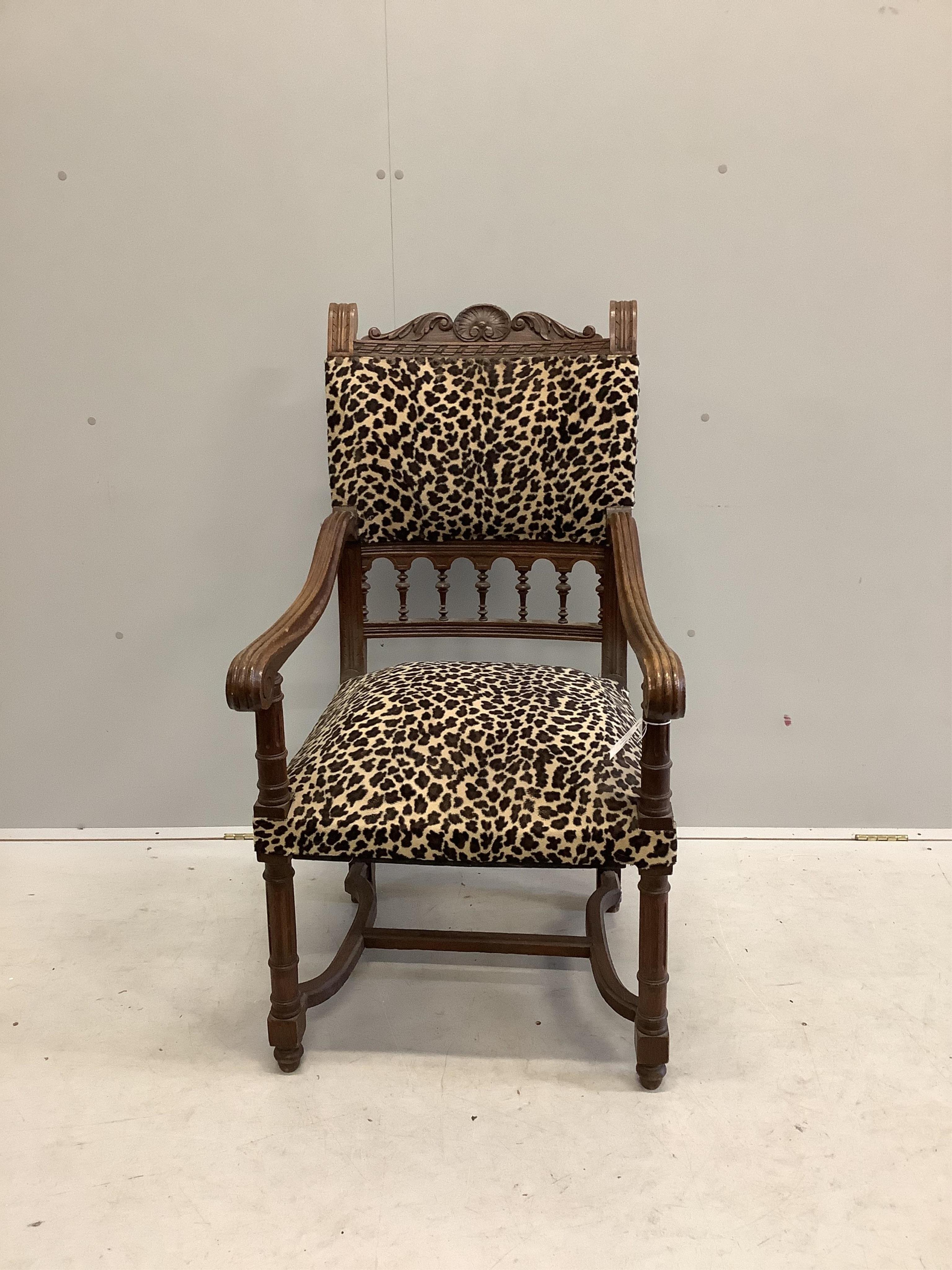 An oak elbow chair with leopard print fabric, and one other oak elbow chair, larger width 59cm, depth 65cm, height 112cm. Condition - fair